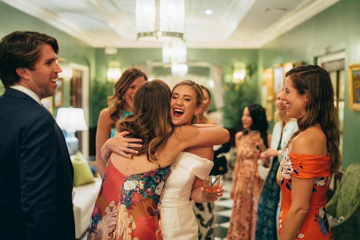 Bride hugs a wedding guest with a big smile on her face and a drink in her hand as wedding guests look on and smile.

New York Wedding Photography. Long Island Wedding Photography. Luxury Local Wedding Photographer. Destination Wedding Photographer.