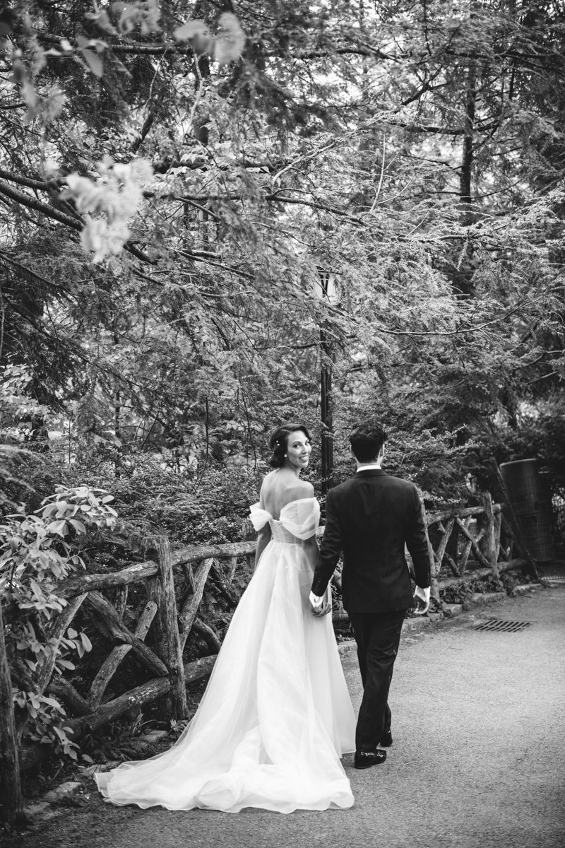 Bride and groom walk hand in hand through the park, walking away from the camera. Bride looks back over her shoulder and smiles at the camera.

Manhattan Wedding Photographer. New York Wedding Photographer. New York Historical Society Wedding. NY Historical Society Weddings.