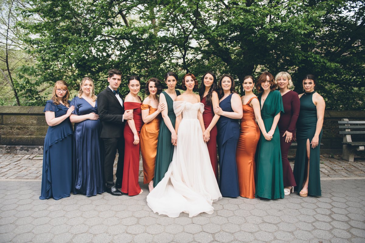 Bride stands on the Manhattan sidewalk with her bridal party posing on either side of her. They are all smiling at the camera.

Manhattan Wedding Photographer. New York Wedding Photographer. New York Historical Society Wedding. NY Historical Society Weddings.