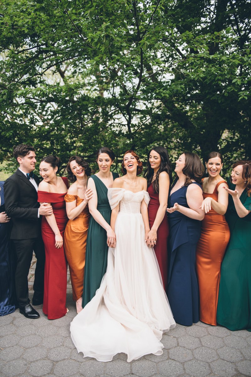 Bride stands in the center of the frame with bridal party standing on either side of her, all smiling and laughing.

Manhattan Wedding Photographer. New York Wedding Photographer. New York Historical Society Wedding. NY Historical Society Weddings.