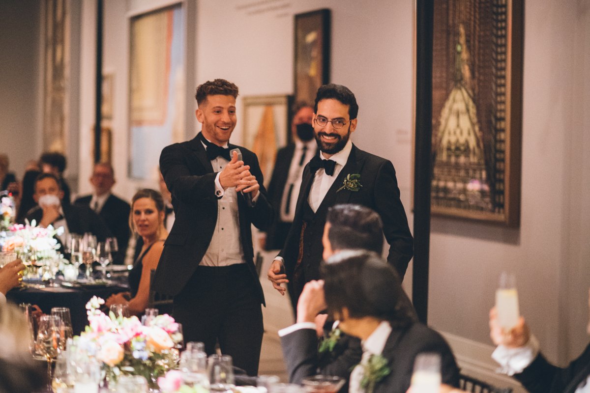 Groomsmen stand among seated wedding guests and give a speech.

Manhattan Wedding Photographer. New York Wedding Photographer. New York Historical Society Wedding. NY Historical Society Weddings.