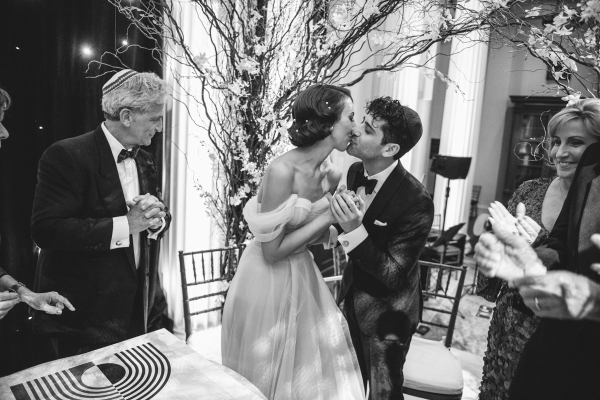 Bride and groom kiss each other with wedding guests beside them.

Manhattan Wedding Photographer. New York Wedding Photographer. New York Historical Society Wedding. NY Historical Society Weddings.