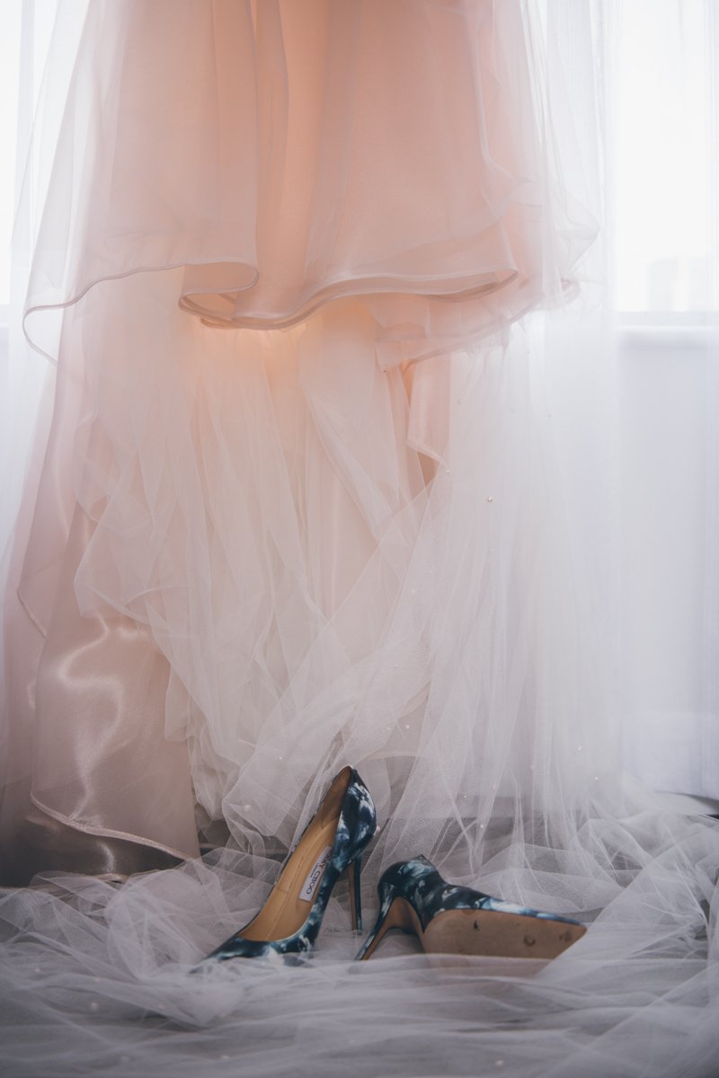 Close up of the bottom of the wedding dress and the black and white heels sitting on the floor below it.

Manhattan Wedding Photographer. New York Wedding Photographer. New York Historical Society Wedding. NY Historical Society Weddings.