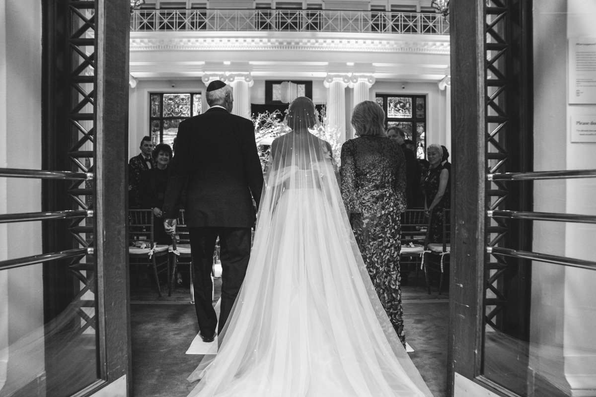 Bride and parents enter the aisle. Photographed from behind.

Manhattan Wedding Photographer. New York Wedding Photographer. New York Historical Society Wedding. NY Historical Society Weddings.