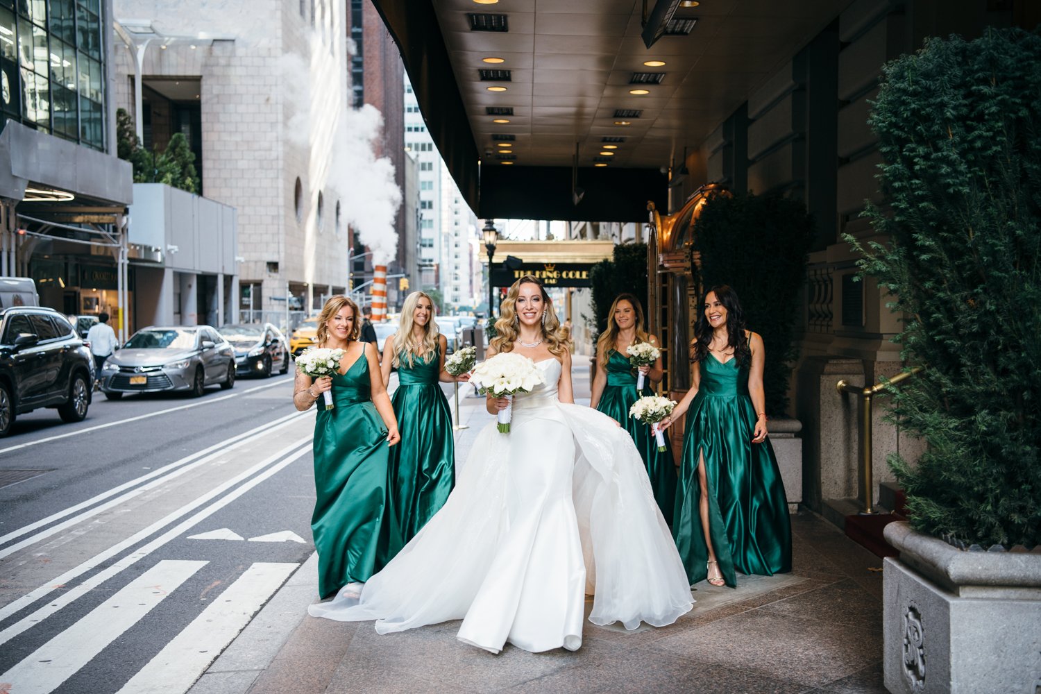 Bride walks down a Manhattan sidewalk with four bridesmaids in green dresses walking behind and smiling at her.

Manhattan Luxury Wedding. New York Luxury Wedding Photographer. Wedding in Manhattan. NYC Luxury Wedding.