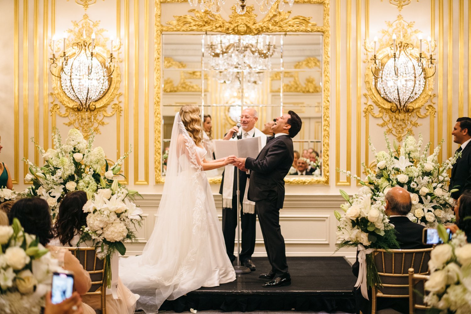 Bride and groom stand at the altar in front of the officiant. They are holding hands and laughing.

Manhattan Luxury Wedding. New York Luxury Wedding Photographer. Wedding in Manhattan. NYC Luxury Wedding.