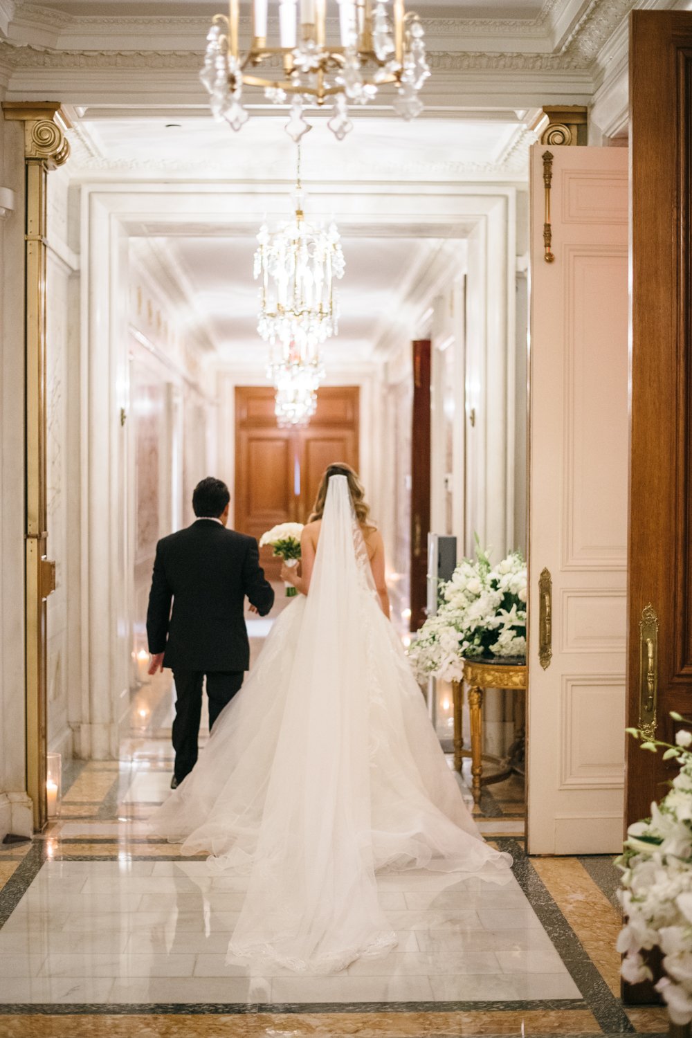 Bride and groom walk down the hall of the St. Regis away from the camera.

Manhattan Luxury Wedding. New York Luxury Wedding Photographer. Wedding in Manhattan. NYC Luxury Wedding.