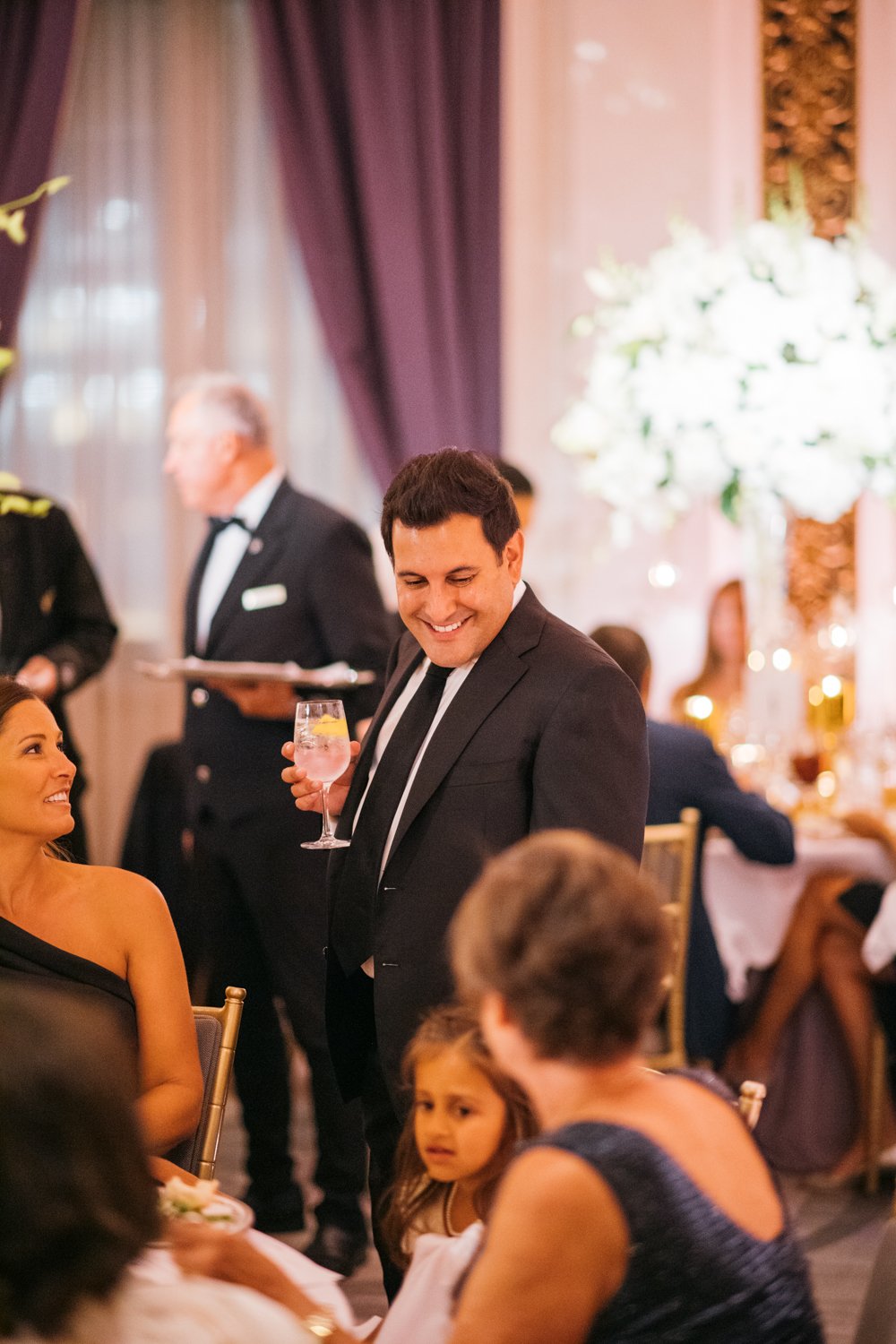 Groom stands next to a table at wedding reception and looks down at the wedding guests seated at the table.

Manhattan Luxury Wedding. New York Luxury Wedding Photographer. Wedding in Manhattan. NYC Luxury Wedding.