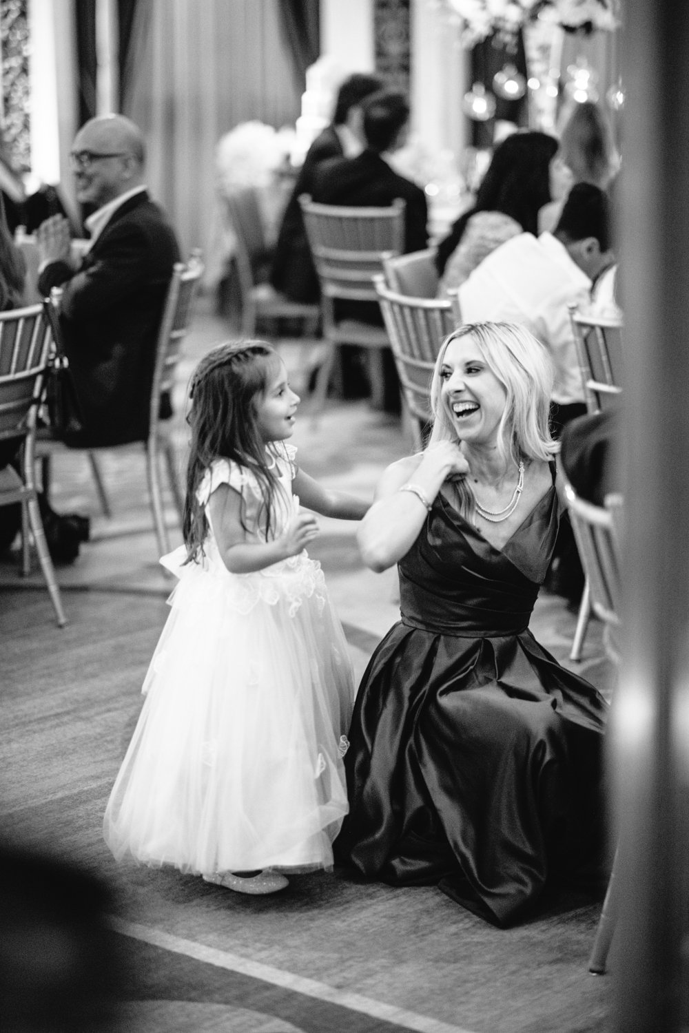 A woman is crouched down on the floor net to a young girl. They are smiling at each other.

Manhattan Luxury Wedding. New York Luxury Wedding Photographer. Wedding in Manhattan. NYC Luxury Wedding.