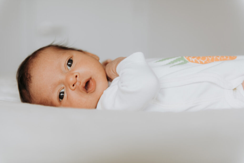 Newborn baby lies down on the bed and looks to the side towards the camera.

Newborn Photography. Brooklyn Newborn Portraits. Lifestyle Newborn Photographer. Brooklyn Family Photography.