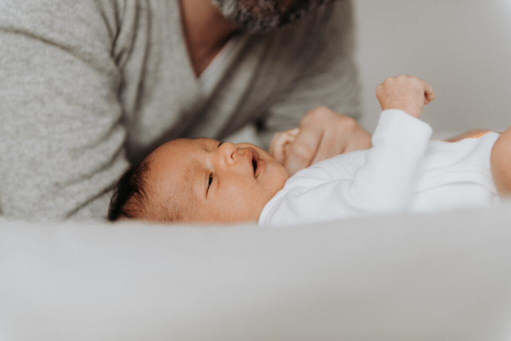 Father leans over his newborn baby, who is lying on the bed.

Newborn Photography. Brooklyn Newborn Portraits. Lifestyle Newborn Photographer. Brooklyn Family Photography.