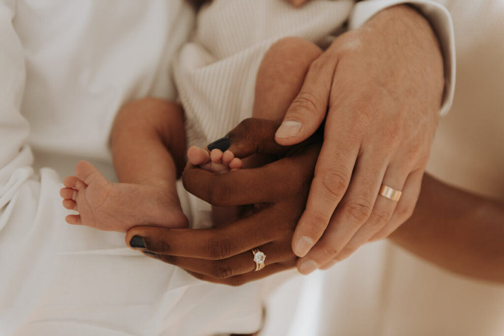 Mother and father's hands are together holding their newborn baby's feet.

Newborn Photography. Brooklyn Newborn Portraits. Lifestyle Newborn Photographer. Brooklyn Family Photography.