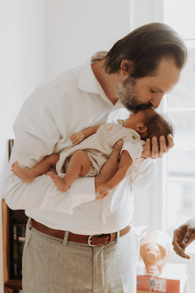 Father holds his newborn baby in his arms and kisses him on the forehead.

Newborn Photography. Brooklyn Newborn Portraits. Lifestyle Newborn Photographer. Brooklyn Family Photography.