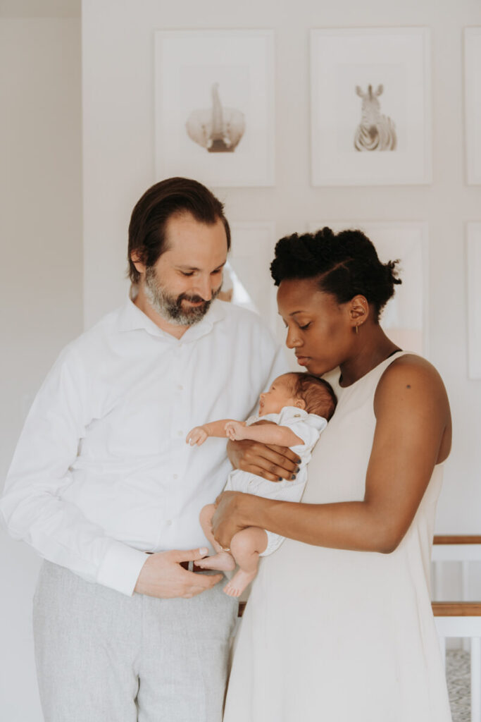 Mother holds her newborn baby in her arms as her husband stands next to her.

Newborn Photography. Brooklyn Newborn Portraits. Lifestyle Newborn Photographer. Brooklyn Family Photography.