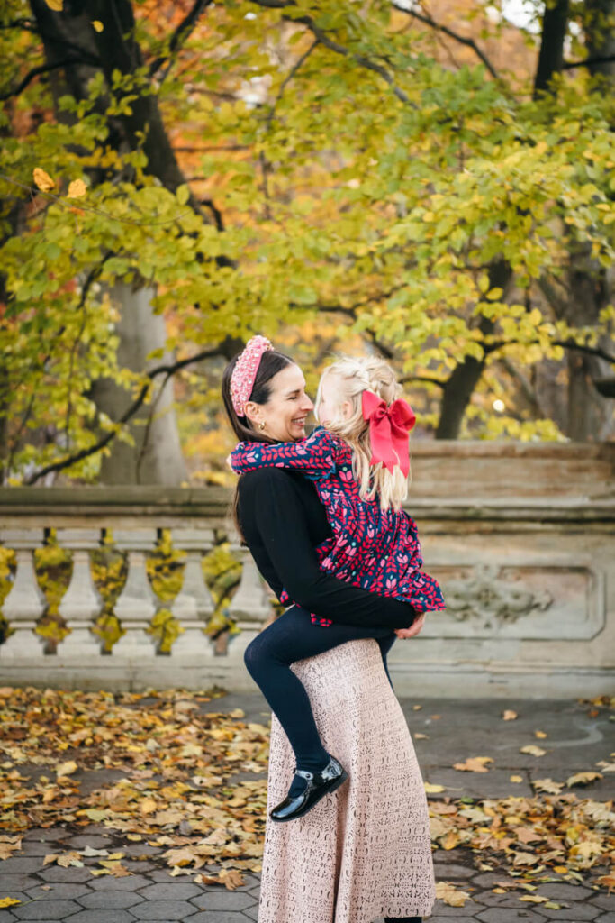 Woman has her daughter on her hip. They are smiling at each other. Photographed in Central Park.

Manhattan Family Portraits. Central Park Family Photography. NYC Family Photographer.