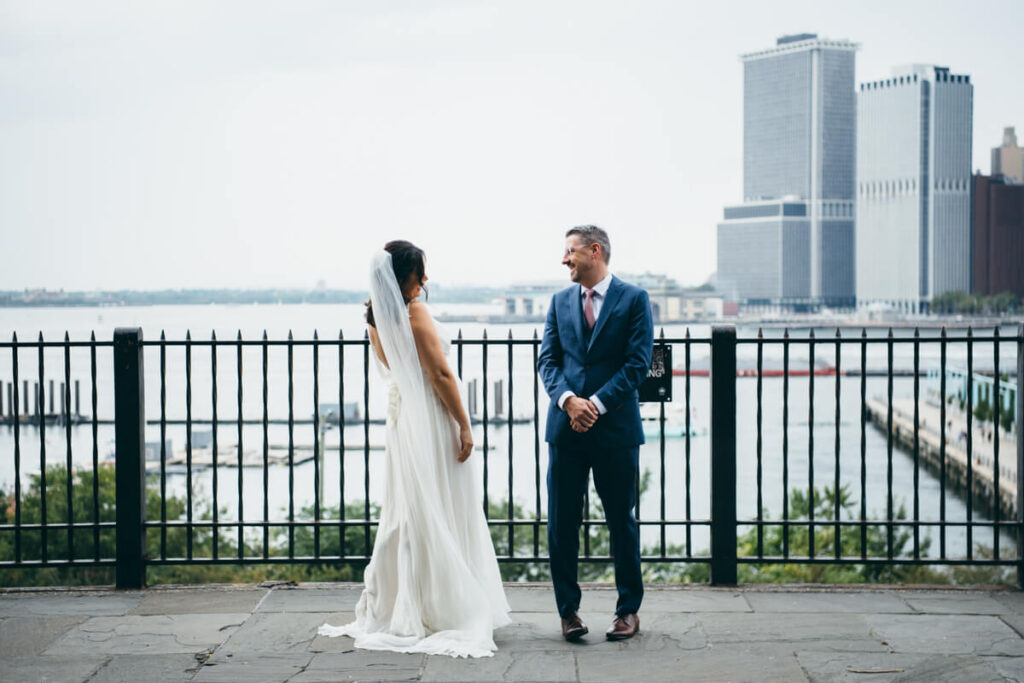 Groom turns around to see the bride for the first time in her wedding dress. They are standing on the Brooklyn Heights Promenade.

NYC Wedding Portraits. Brooklyn Wedding Photographer. Luxury Local Wedding Photography.