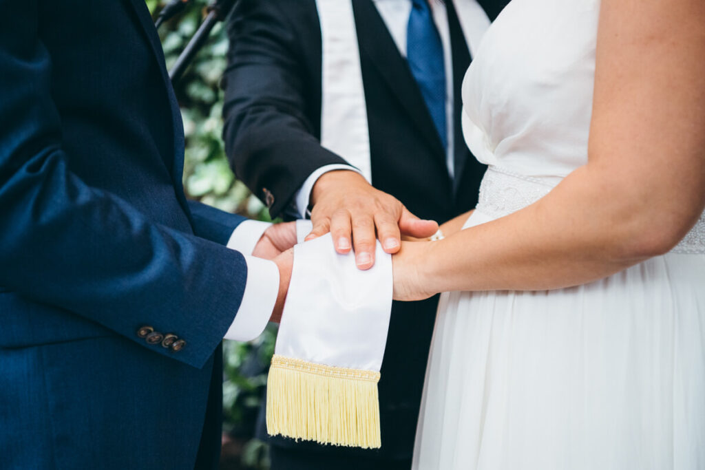 Wedding officiant holds his hand on top of the held hands of the bride and groom.

NYC Wedding Portraits. Brooklyn Wedding Photographer. Luxury Local Wedding Photography.