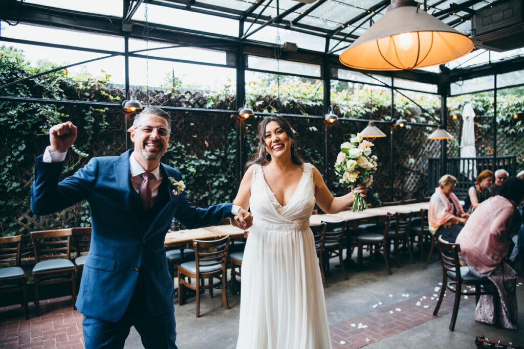 Bride and groom hold hands with their arms in the air and smile at the camera.

NYC Wedding Portraits. Brooklyn Wedding Photographer. Luxury Local Wedding Photography.