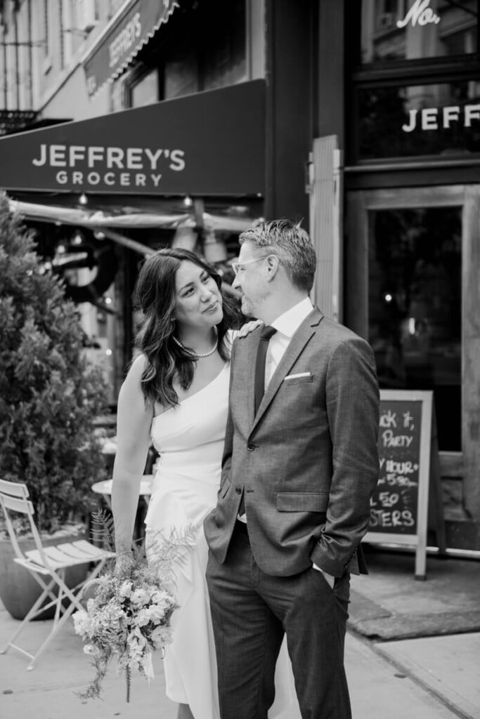 Man and woman pose outside a Jeffrey's Grocery and smile at each other.

NYC Engagement Portraits. Manhattan Engagement Photographer. 