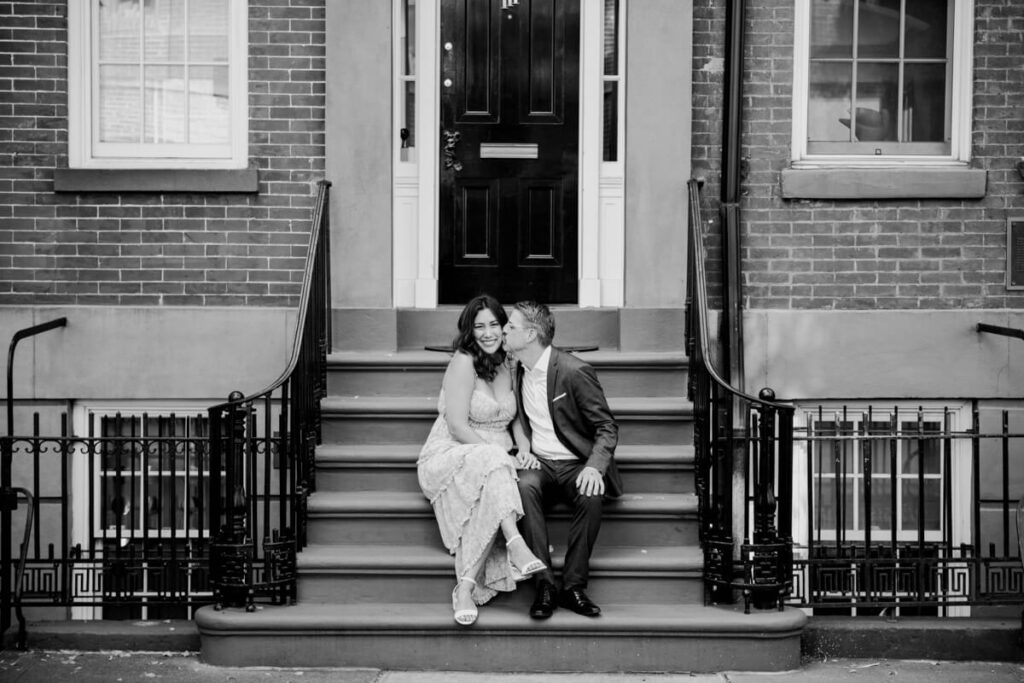 Man and woman sit on a stoop in New York City. She smiles at the camera and he kisses her cheek.

NYC Engagement Portraits. Manhattan Engagement Photographer. 