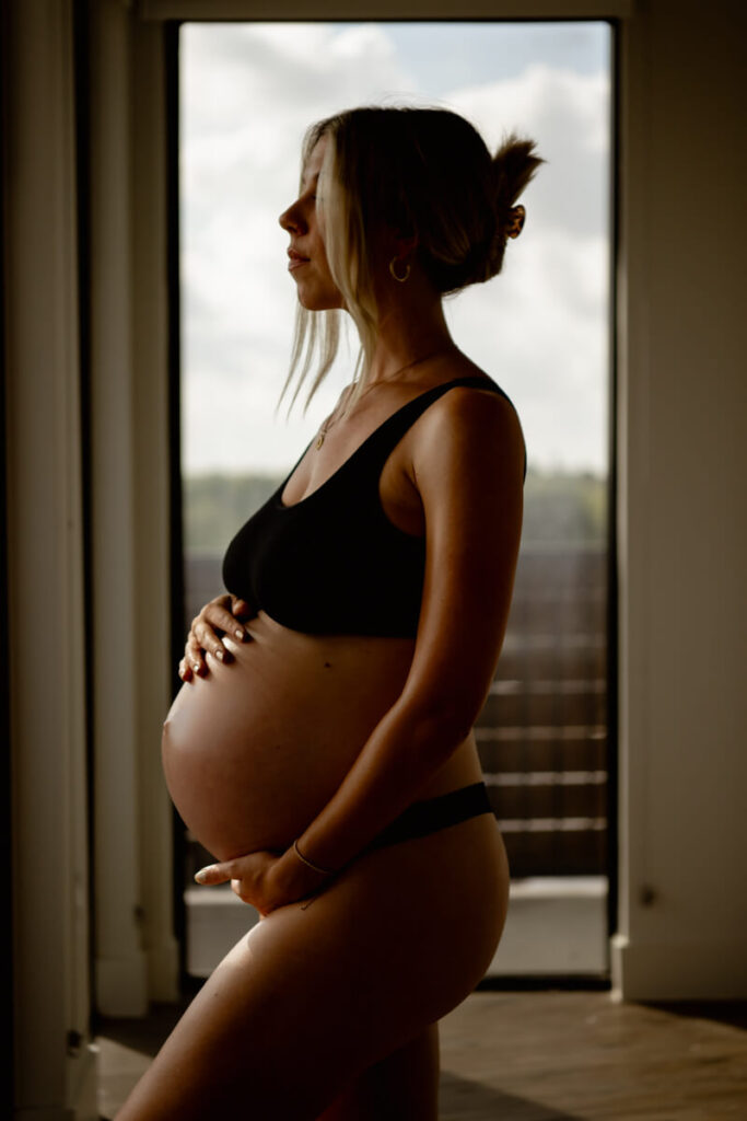 Pregnant woman stands in front of a window wearing a black bra and underwear, with her hands on her belly.

Austin Maternity Photography. Austin Maternity Photographer. Austin Maternity Portraits. 