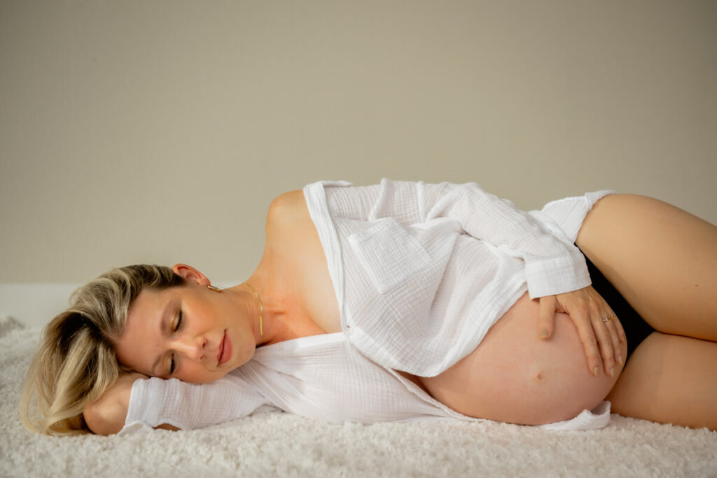 Pregnant woman lies on her side on a fluffy rug, wearing only a white button down, hand on her belly, eyes closed.

Austin Maternity Photography. Austin Maternity Photographer. Austin Maternity Portraits. 
