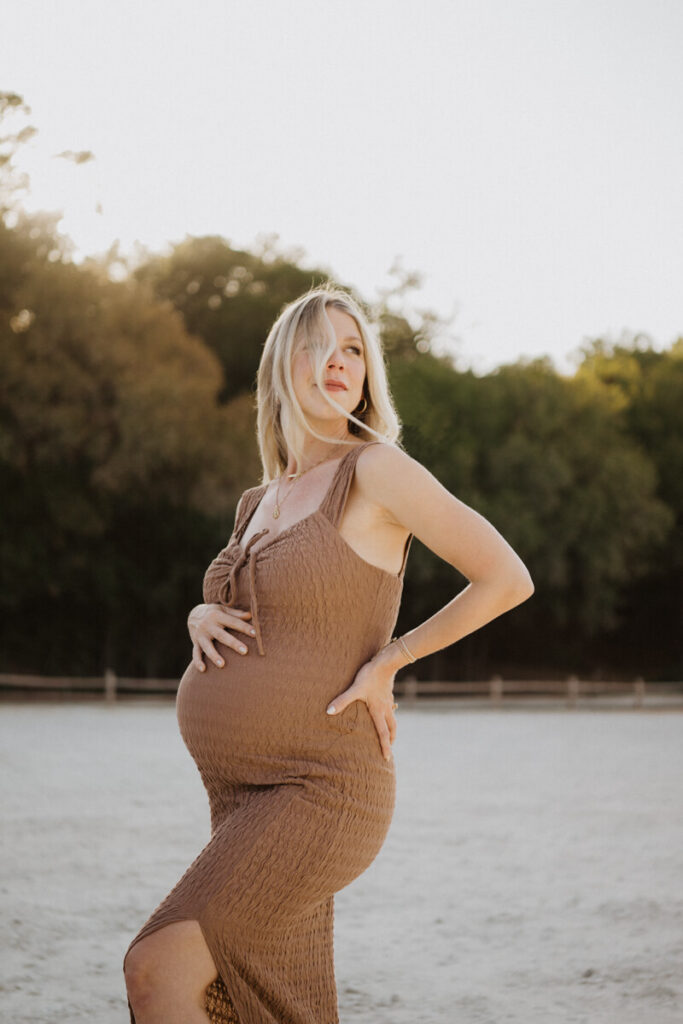 Pregnant woman with her hand on her belly and smiling off in the distance. Maternity session photographed at Zilker Park in Austin.

Zilker Maternity Portraits. Austin Photography. Zilker Maternity Photographer.