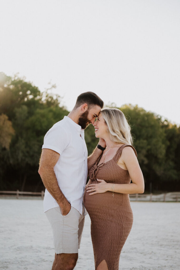Husband and pregnant wife face each other and look lovingly into each other's eyes as their foreheads touch. Maternity session photographed at Zilker Park in Austin.

Zilker Maternity Portraits. Austin Photography. Zilker Maternity Photographer.