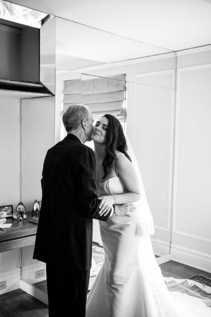 Bride is leaning forward to her father, who is kissing her on the cheek. Black and white photograph.

Luxury NYC Wedding Photography. Manhattan Luxury Wedding Photographer. NYC Luxury Wedding. University Club Wedding Photographer.
