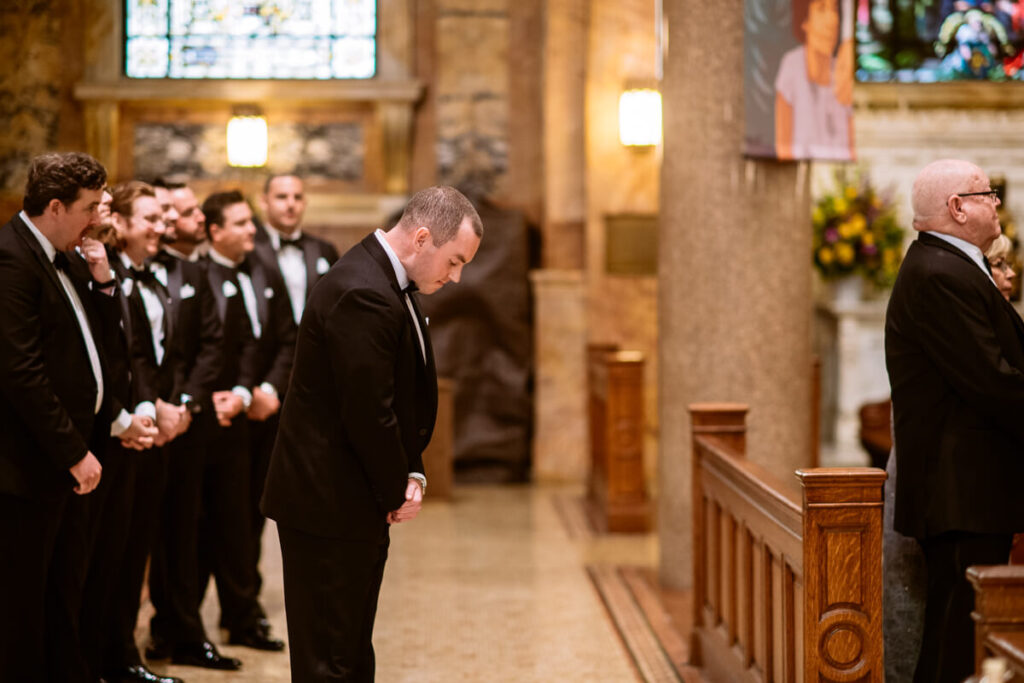 Groom is standing in the church, looking at his feet. His groomsmen are lines up beside him.

Luxury NYC Wedding Photography. Manhattan Luxury Wedding Photographer. NYC Luxury Wedding. University Club Wedding Photographer.
