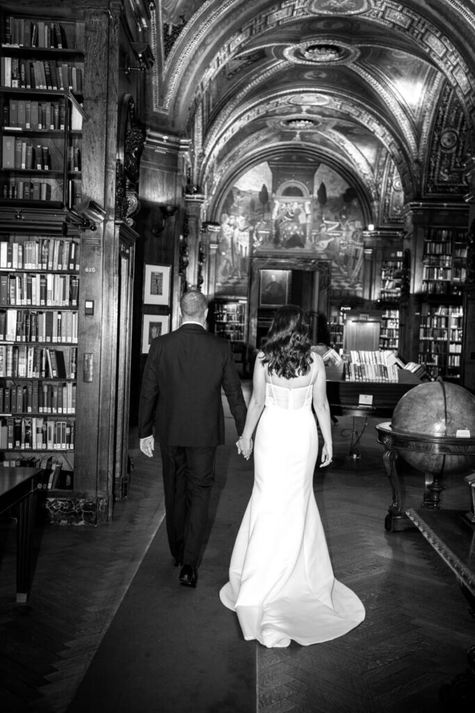 Bride and groom are photographed from behind as they walk through the library at the University Club in Manhattan. Black and white photograph.

Luxury NYC Wedding Photography. Manhattan Luxury Wedding Photographer. NYC Luxury Wedding. University Club Wedding Photographer.