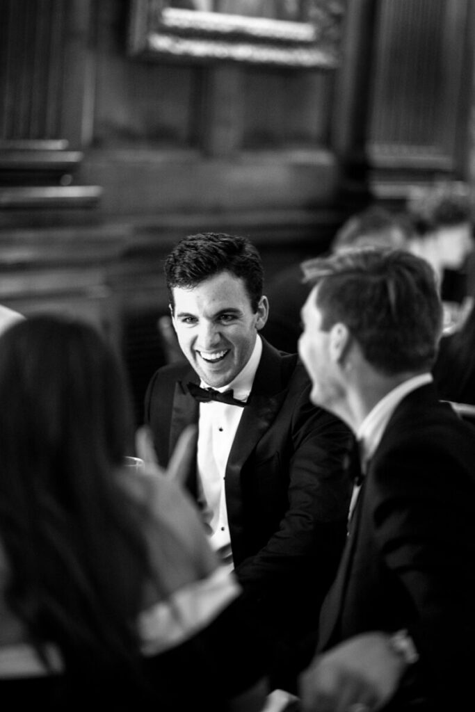 A groomsmen is laughing with other wedding guests at the University Club in Manhattan. Black and white photograph.

Luxury NYC Wedding Photography. Manhattan Luxury Wedding Photographer. NYC Luxury Wedding. University Club Wedding Photographer.