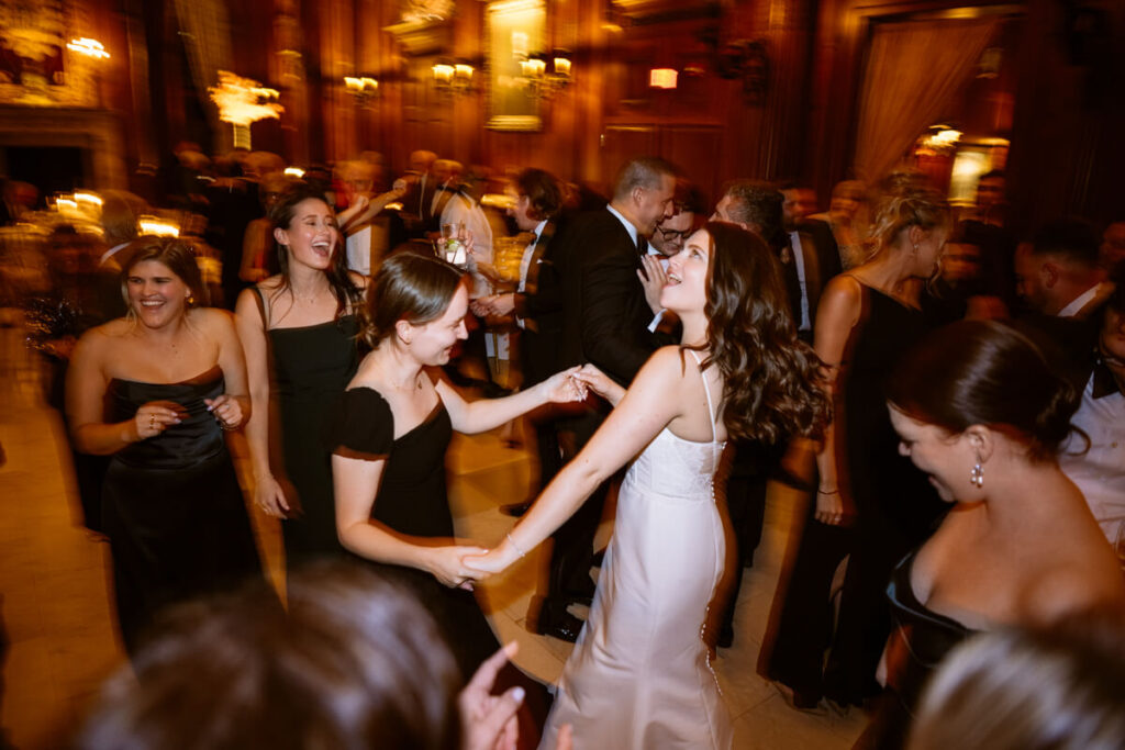 Bride dancing with wedding guests in the University Club in Manhattan.

Luxury NYC Wedding Photography. Manhattan Luxury Wedding Photographer. NYC Luxury Wedding. University Club Wedding Photographer.