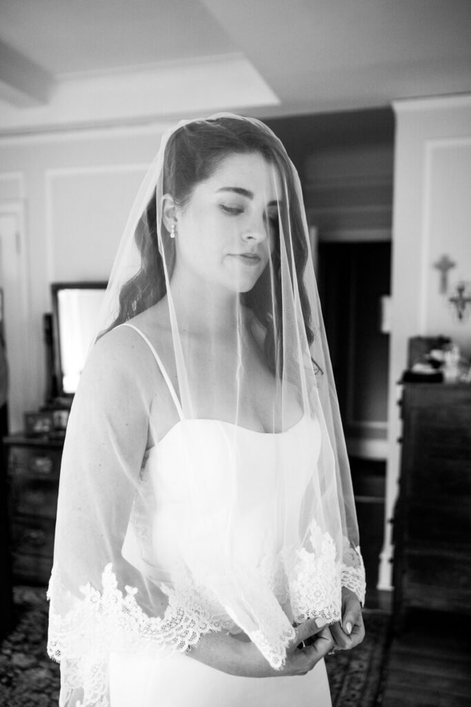 Close up of bride with her veil over her face. She is smiling and looking toward the ground. Black and white photograph.

Luxury NYC Wedding Photography. Manhattan Luxury Wedding Photographer. NYC Luxury Wedding. University Club Wedding Photographer. NYC Bride Portraits.