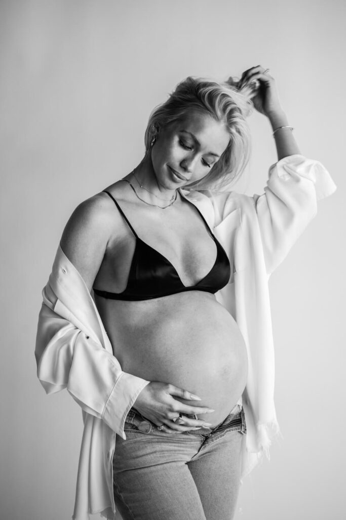 Calvin Klein inspired black and white maternity photo with pregnant woman in white button up photographed by Austin maternity photographer kat harris