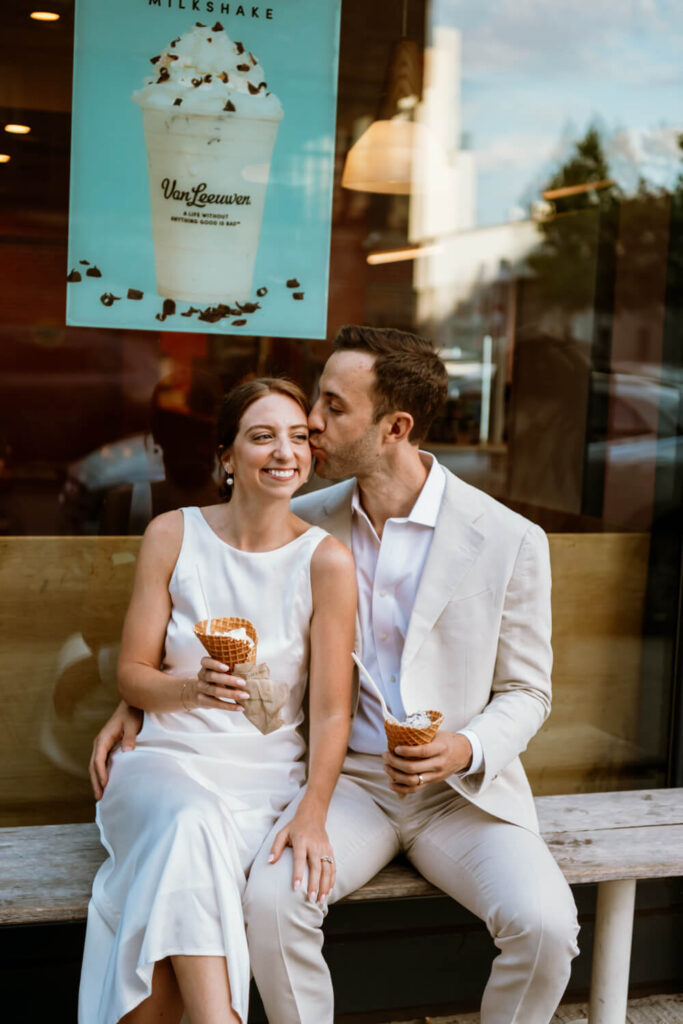 Engaged Williamsburg Brooklyn couple steals a kiss and celebrates their engagement by going back to the spot of their first date for ice cream at Van Leeuwen ice cream on Wythe.