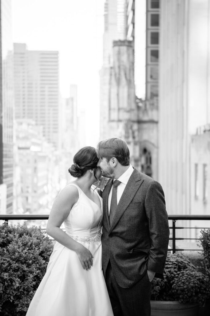 Quiet moment between the bride and groom during their portraits at University Club on the rooftop terrace photographed by New York City wedding photographer Kat Harris.