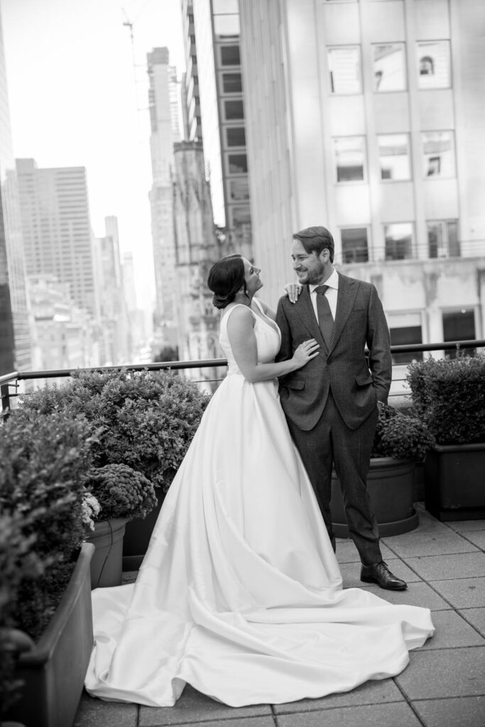 Editorial black and white photo of bride and groom looking at each other during wedding portraits at the University Club of New York photographed by New York City wedding photographer Kat Harris.