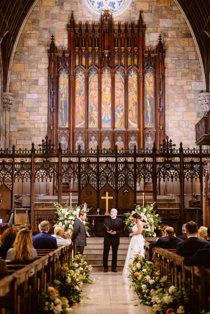 bride and groom share vows during their wedding ceremony at The First Presbyterian Church on 12th street and 5th ave photographed by New York City wedding photographer Kat Harris.