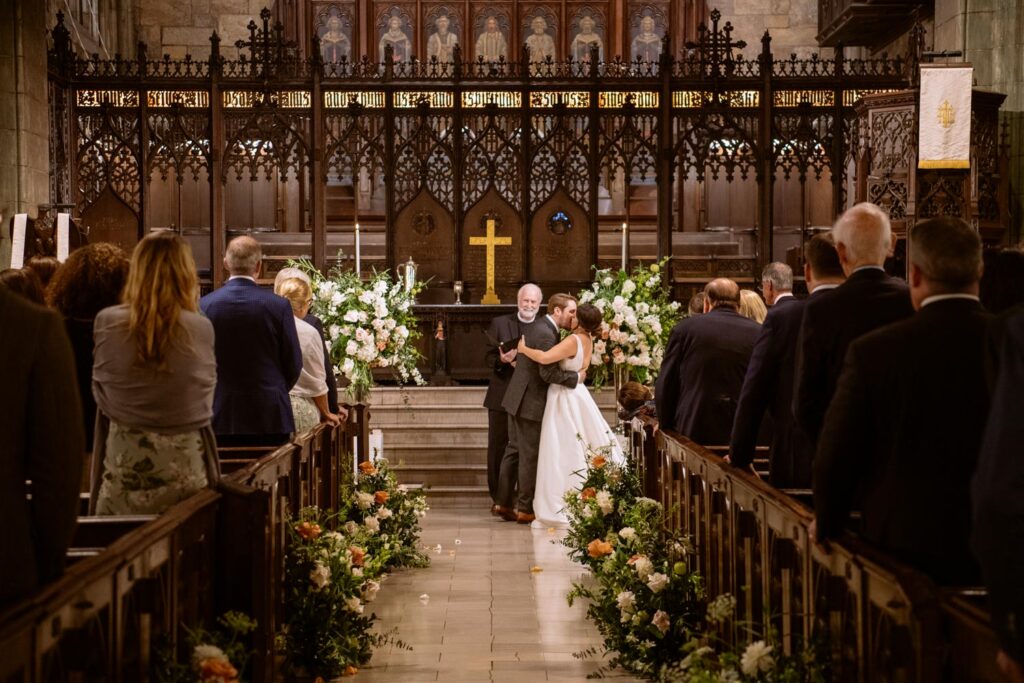 Bride and Groom's first kiss as a married couple at the end of their wedding ceremony at The First Presbyterian Church on 12th street and 5th ave photographed by New York City wedding photographer Kat Harris.