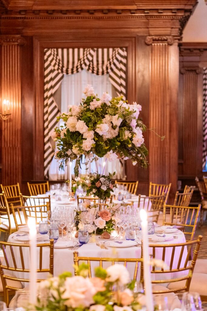 Room photo of the reception florals and tables at the University Club of NY wedding reception photographed by New York City wedding photographer Kat Harris.