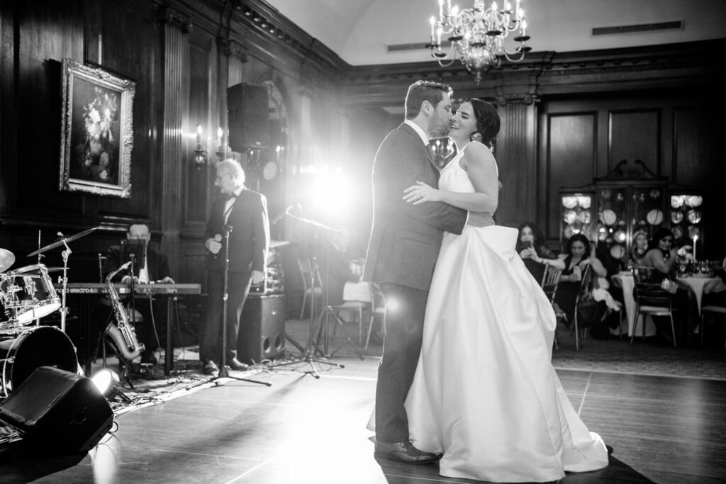 Bride and groom share an intimate moment during their first dance as husband and wife during their New York City University Club wedding reception photographed by New York City wedding photographer Kat Harris.